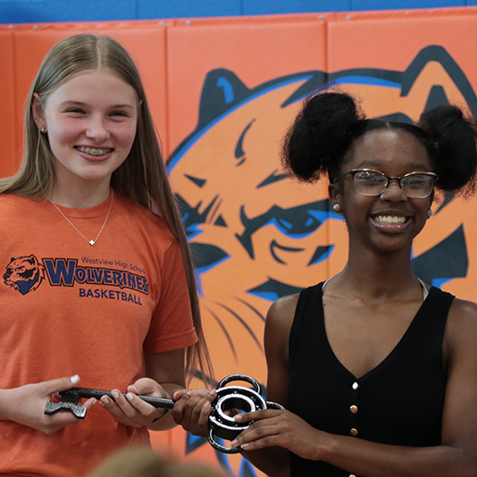  Two students hold a ceremonial key to Westview